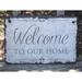 Gracie Oaks Irasburg Welcome To Our Home Wall Décor Stone in Gray | 10 H x 16 W in | Wayfair AE1EE90D8AC749828936A037E5CD6074