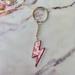 Urban Outfitters Accessories | Brand New Pink Cow Print Lightning Bolt Keychain | Color: Pink/White | Size: Os