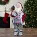 Northlight Seasonal 2' Standing Santa Christmas Figure Carrying Snow Shoes & Presents Wood in Brown | 24 H x 12 W x 12 D in | Wayfair