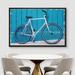 IDEA4WALL Road Bike Standing By The Blue Wall - Floater Frame Painting on Canvas in White | 24 H x 36 W x 1.5 D in | Wayfair 8022271714617