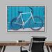 IDEA4WALL Road Bike Standing By The Blue Wall - Floater Frame Painting on Canvas in White | 24 H x 36 W x 1.5 D in | Wayfair 8022271714655