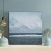 Rosecliff Heights A Bird Far Away Flying Over The Beach Under Gray Sky - 1 Piece Rectangle Graphic Art Print On Wrapped Canvas in Blue | Wayfair