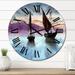 Designart 'Sailing Boats In The Sea In Evening With City' Nautical & Coastal wall clock