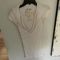 American Eagle Outfitters Tops | American Eagle Tank Top. Deep V-Neck. Embellished Around V-Neck. Size S/P | Color: Gold/Tan/White | Size: Sp