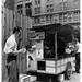 Mid adult man eating food near a hot dog stand New York City New York USA Poster Print (18 x 24)