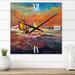 Designart 'Sailships On The Ocean Waves During Orange Sunset' Nautical & Coastal wall clock