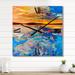 Designart 'Orange Sunset Over Whirly Blue Waves' Nautical & Coastal Metal Wall Clock