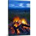 Great BIG Canvas | Close up view of a camp fire with a view of the Chugach Mountain in the distance Canvas Wall Art - 24x36