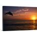 Great BIG Canvas | Silhouette Of Bottlenose Dolphin Leaping Over Ocean At Sunset Caribbean Sea Canvas Wall Art - 48x32