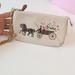 Coach Bags | Coach Large Wristlet 19 With Dreamy Veggie Horse And Carriage | Color: Cream/Gold | Size: Os