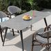 Bayou Breeze Aleras Rectangular 4 - Person 62.99" Long Outdoor Dining Set Stone/Concrete/Wicker/Rattan in Gray | 62.99 W x 31.5 D in | Wayfair