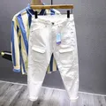 Jean slim en denim blanc pour homme streetwear chic avec poche coupe couvertes mode de créateur