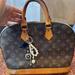 Louis Vuitton Bags | Louis Vuitton Alma Shoulder Bag Pm Brown Canvas/Leather. With Bag Charm | Color: Brown/Tan | Size: Pm