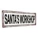 The Holiday Aisle® Santa's Workshop Christmas Metal Sign Metal | 5.75 H x 15.5 W x 0.04 D in | Wayfair A85953818458428E9635358CF1F4F32B