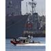 A Coast Guard rigid-hull inflatable boat from U.S. Coast Guard Station Little Creek speeds toward th - Laminated Poster Print -12 Inch by 18 Inch with Bright Colors and Vivid Imagery