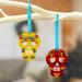 'Pair of Hand-Painted Wood Day of the Dead Skull Ornaments'