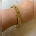 Coach Jewelry | Coach Bangle Bracelet W/ Gold Tone Studs | Color: Gold | Size: Os