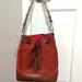 Dooney & Bourke Bags | Dooney & Bourke Drawstring Bucket Bag Orange Suede Leather | Color: Brown/Orange | Size: Os