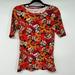 Lularoe Tops | Lularoe T-Shirt Womens Sz S Red Orange Floral Christmas Man Print Fitted Stretch | Color: Orange | Size: S