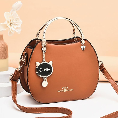 Schwarze Handtasche aus Kunstleder für Damen mit goldenem Katzenanhänger und Metallgriff – stilvolle Umhängetasche für den lässigen oder formellen Gebrauch