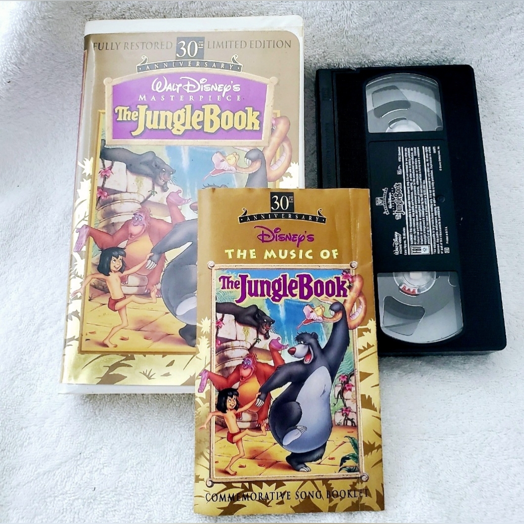 Disney Media | The Jungle Book 30th Anniversary Vhs With Commemorative Song Book | Color: Purple/Yellow | Size: Vhs