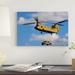 East Urban Home 'A US Army CH-47 Chinook Helicopter Transports a Humvee' Photographic Print on Canvas in Black/Blue | 8 H x 12 W x 0.75 D in | Wayfair
