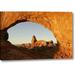 Ebern Designs 'Ut, Arches Np Turret Arch Through North Window' Photographic Print on Wrapped Canvas in Blue/Brown | 16 H x 24 W x 1.5 D in | Wayfair