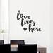 Wallums Wall Decor Love Lives Here Quote Wall Decal Vinyl, Glass in Black | 28 H x 31 W in | Wayfair quotes-love-lives-here-31x28_Black
